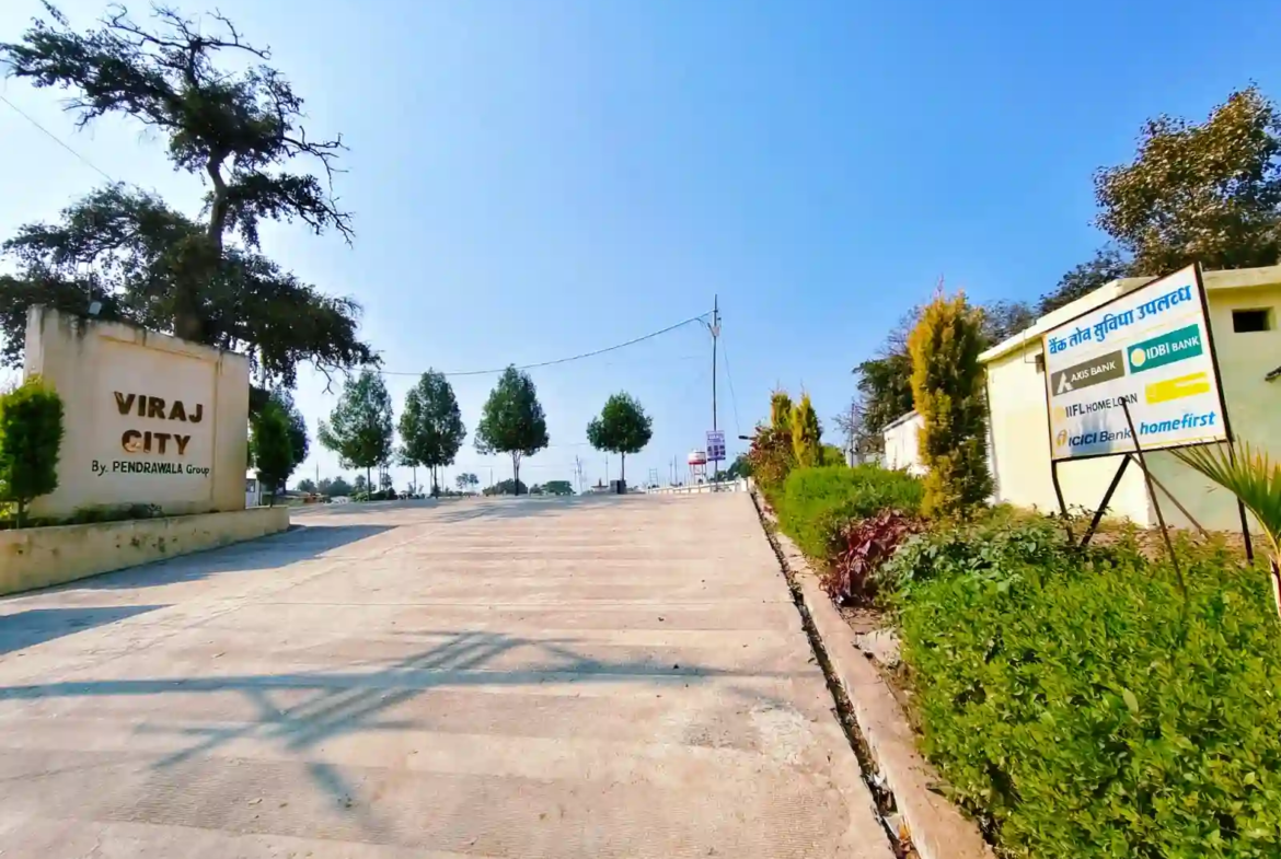 Grand entrance gate of Viraj City by Pendrawala Group in Betma featuring wide 30-feet cement roads and 24/7 security.