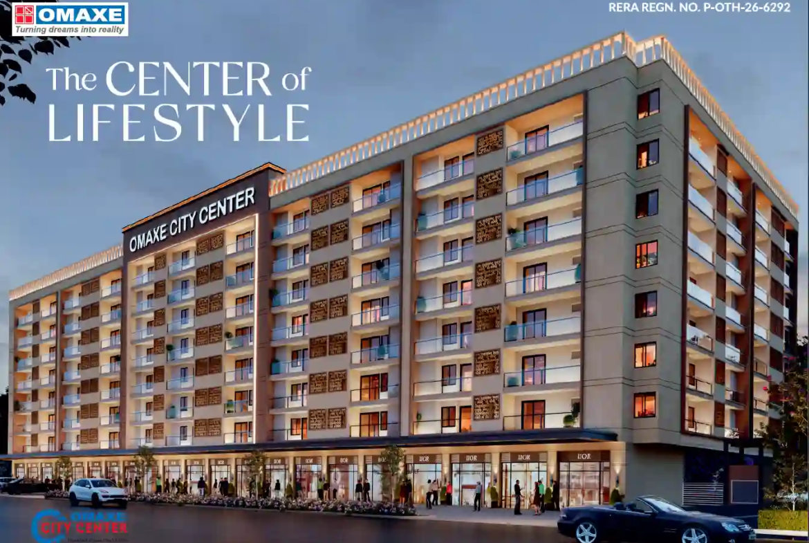 Exterior twilight view of Omaxe City Center modern residential apartments and ground-floor commercial shops in Indore.