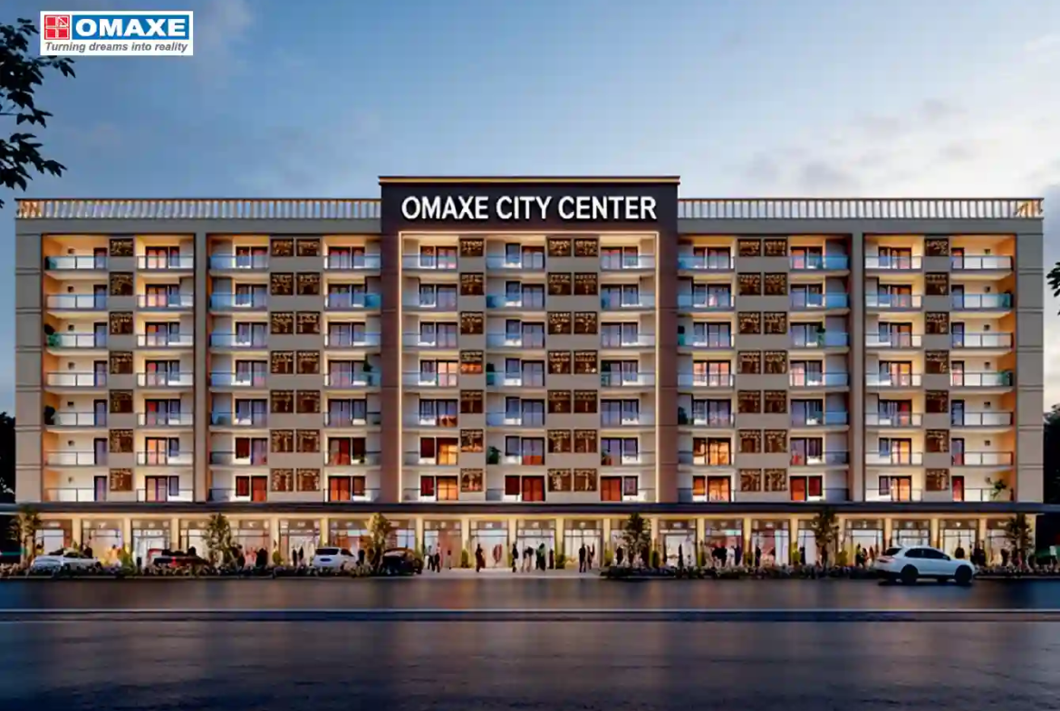 Beautifully landscaped roundabout with golden statues and wide asphalt roads inside Omaxe City township, Indore.