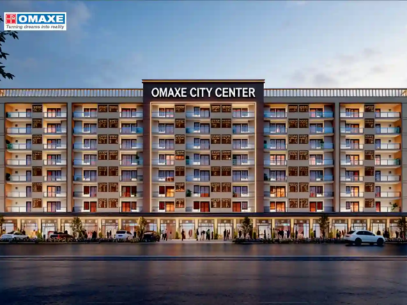 Beautifully landscaped roundabout with golden statues and wide asphalt roads inside Omaxe City township, Indore.