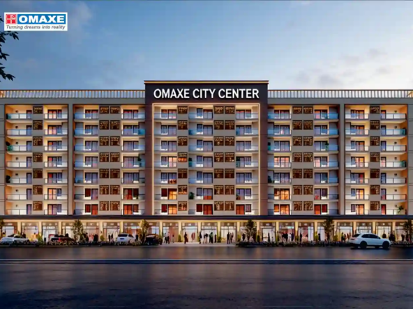 Beautifully landscaped roundabout with golden statues and wide asphalt roads inside Omaxe City township, Indore.